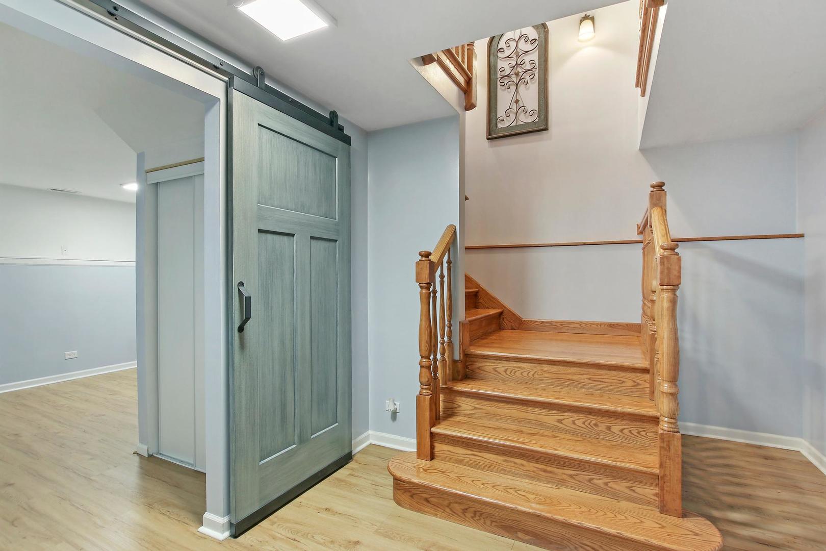 703 Crestview Drive Ingleside, IL 60041 - Photo 24 of 28 a view of staircase with white walls and a window