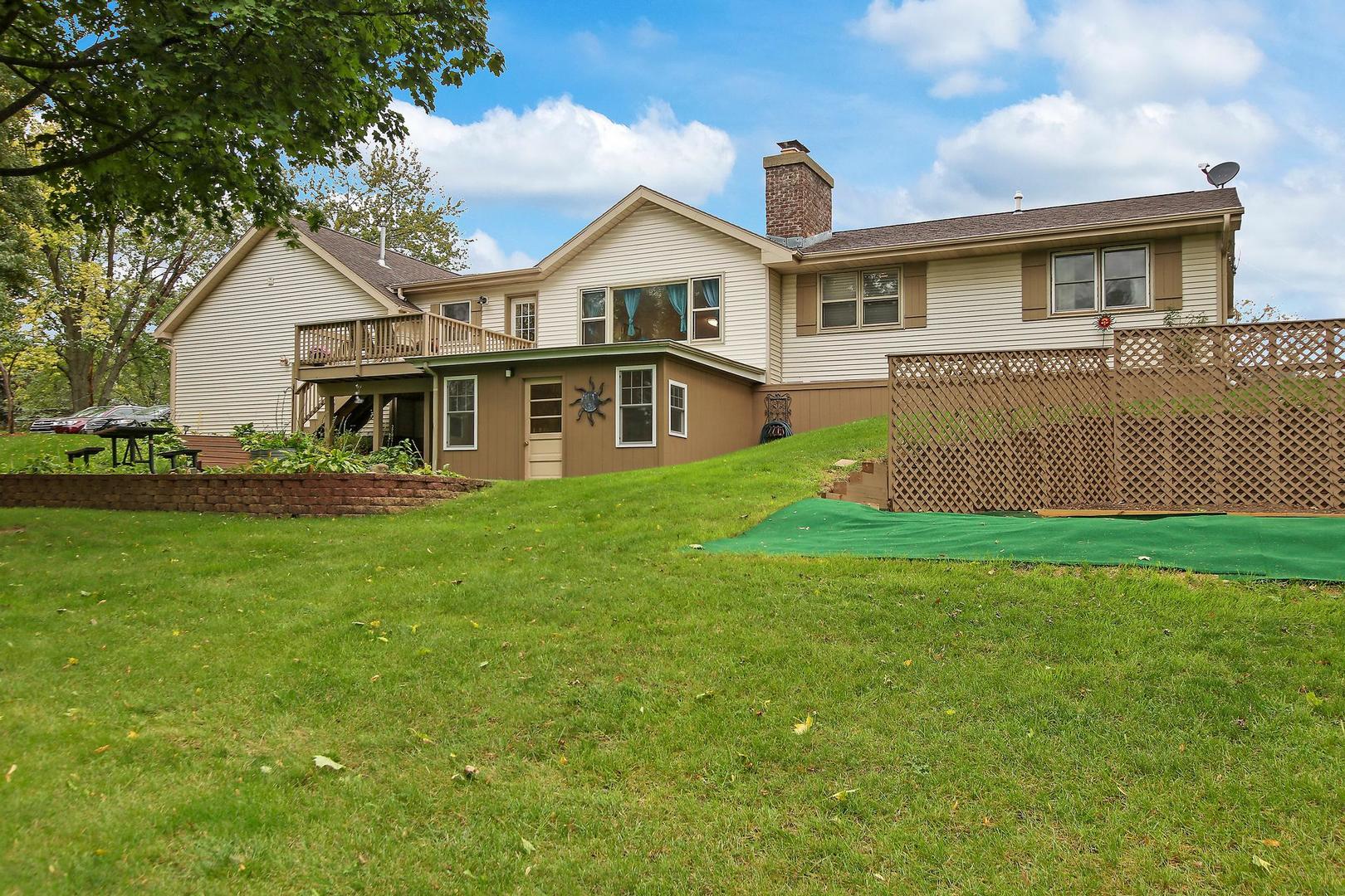 703 Crestview Drive Ingleside, IL 60041 - Photo 27 of 28 a front view of a house with a garden and yard
