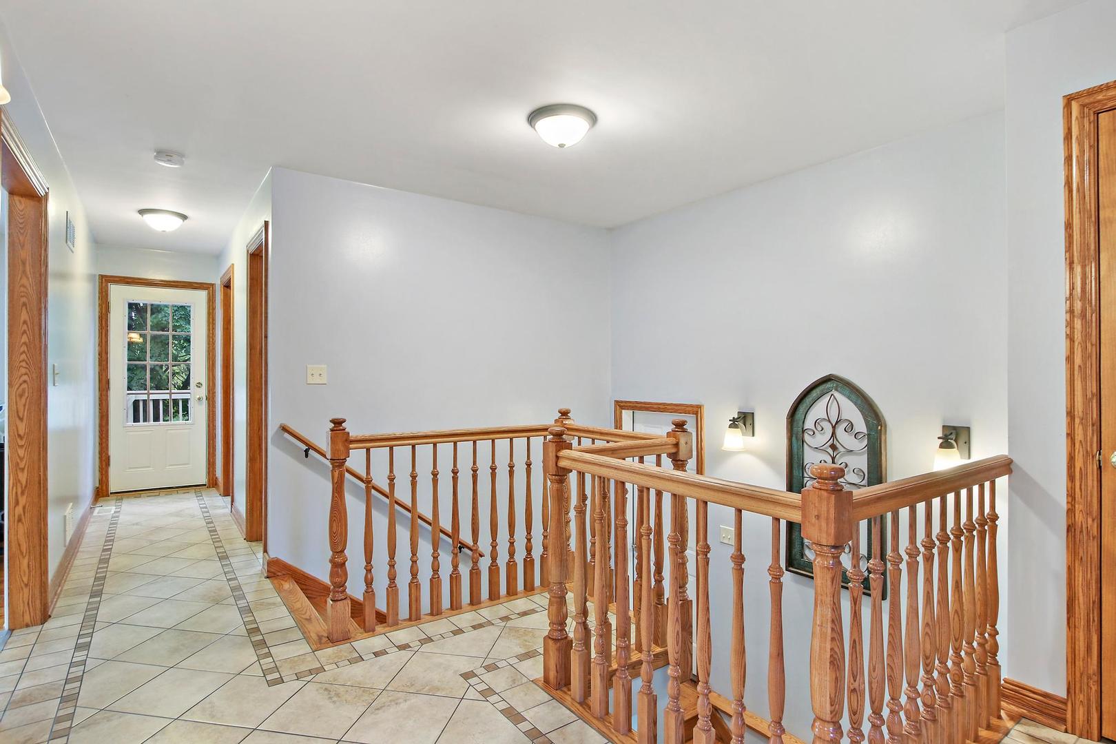 703 Crestview Drive Ingleside, IL 60041 - Photo 4 of 28 a view of staircase with railing and a rug