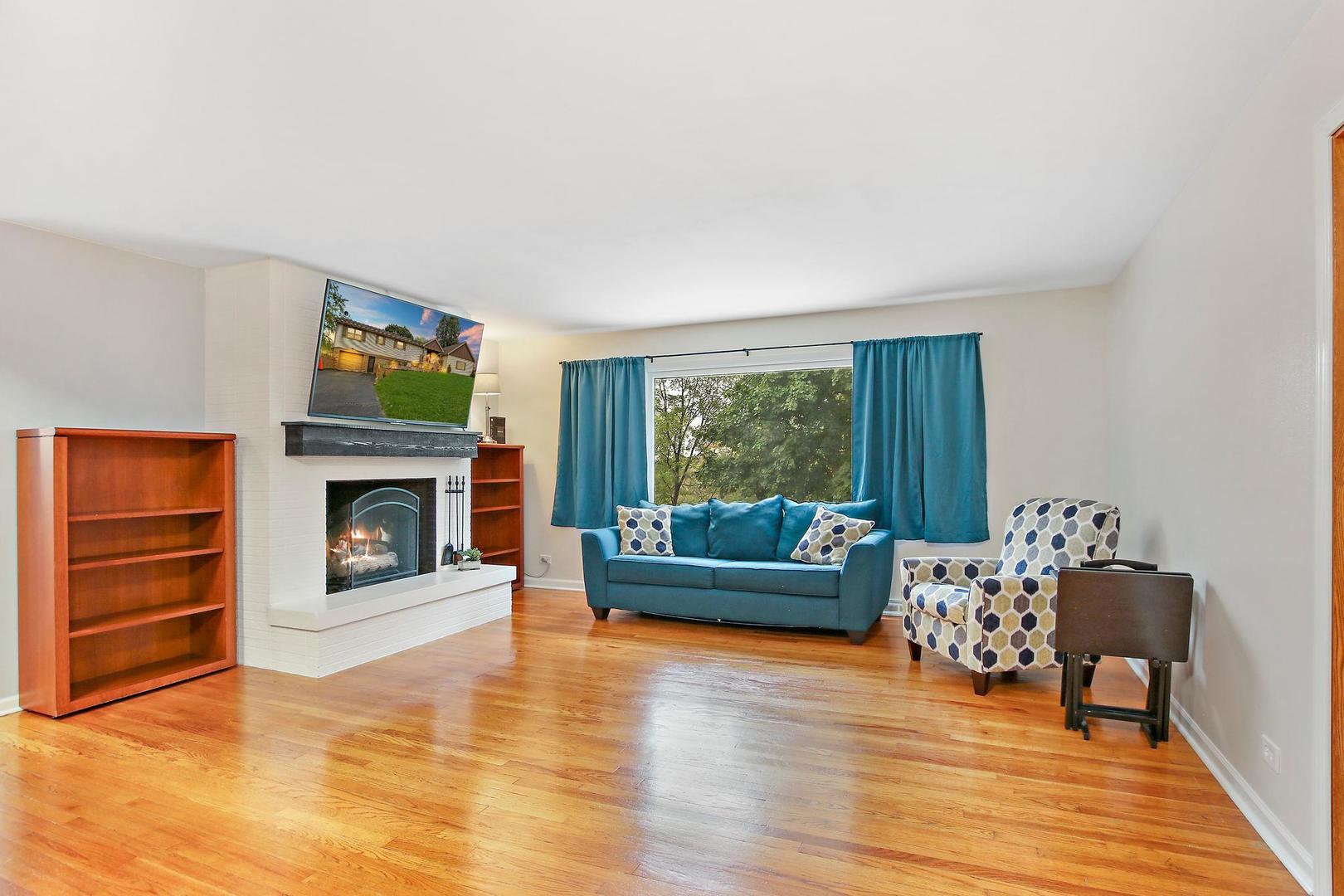 703 Crestview Drive Ingleside, IL 60041 - Photo 7 of 28 a living room with furniture and a fireplace