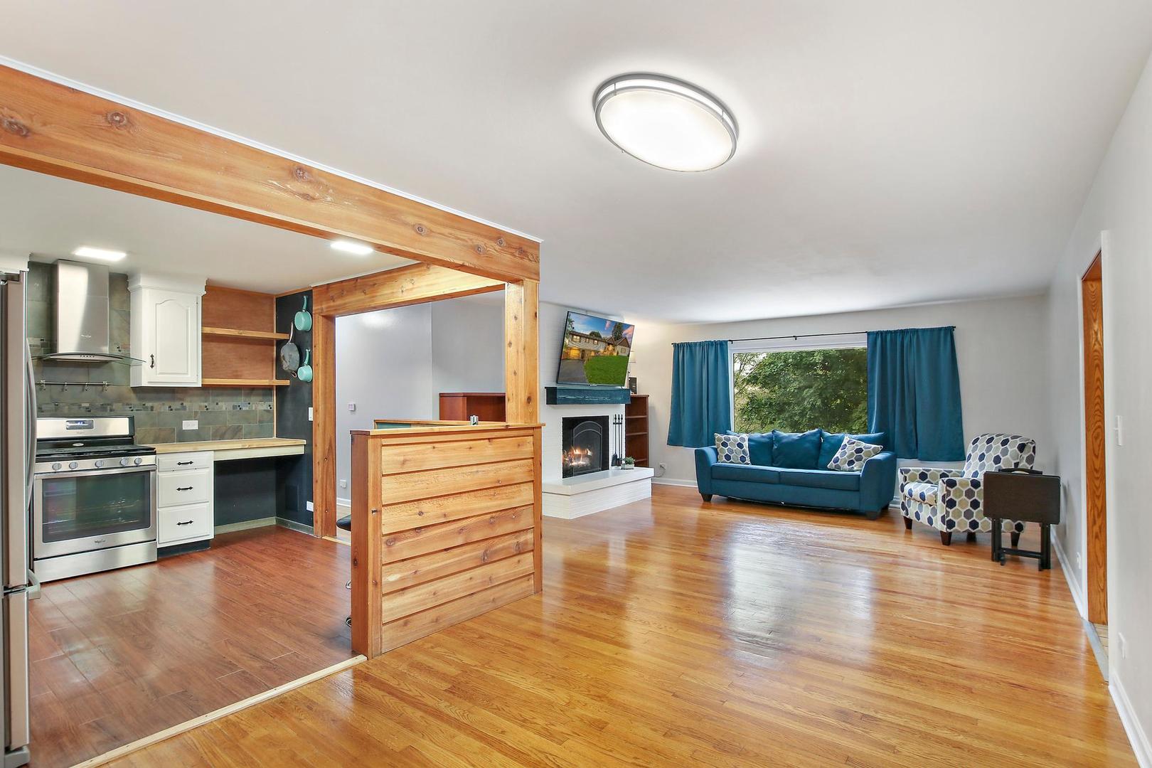 703 Crestview Drive Ingleside, IL 60041 - Photo 9 of 28 a view of a living room kitchen and a wooden floor