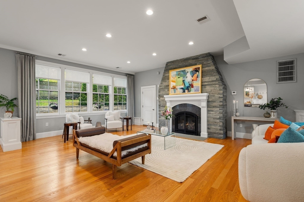 165 Park Avenue, Unit 165 Arlington, MA 02476 - Photo 8 of 32 a living room with furniture a fireplace and a floor to ceiling window