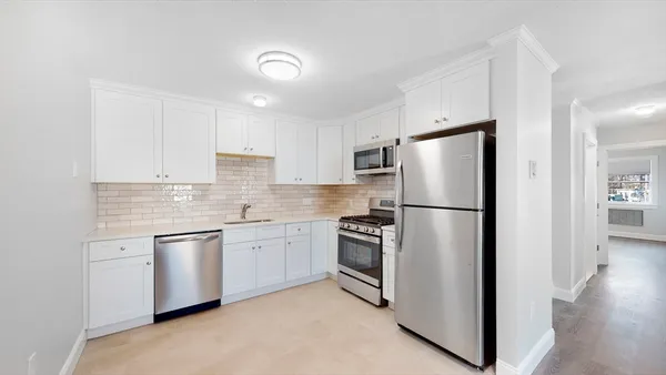 a kitchen with stainless steel appliances granite countertop a refrigerator sink and stove