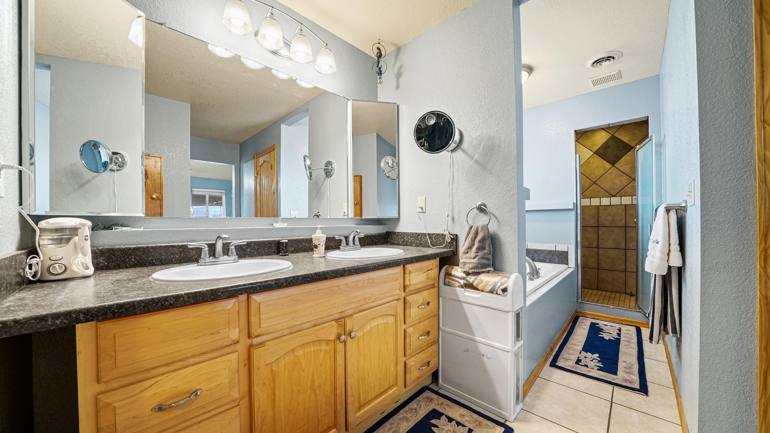 20786 Iris Road Austin, CO 81410 - Photo 21 of 38 a bathroom with a sink a mirror and a shower