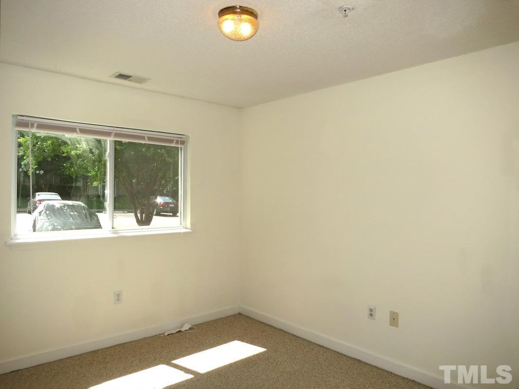 303 Smith Level Road, Unit F11 Chapel Hill, NC 27516 - Photo 11 of 14 a view of a small space with wooden floor and a window