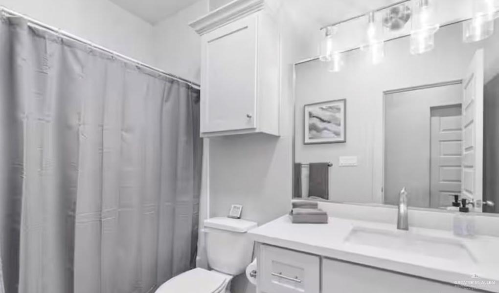 2310 Treasure Cove Harlingen, TX 78550 - Photo 11 of 23 a bathroom with a granite countertop sink and a mirror