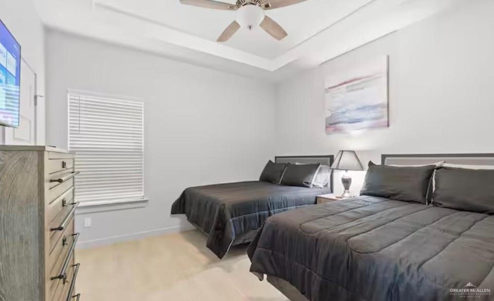 2310 Treasure Cove Harlingen, TX 78550 - Photo 13 of 23 a bedroom with two beds and ceiling fan