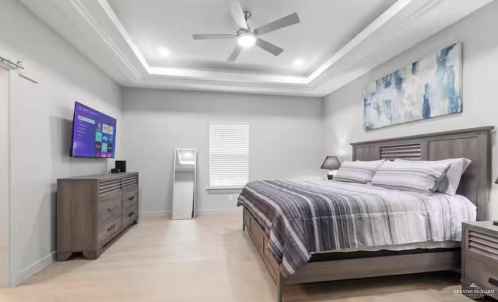 2310 Treasure Cove Harlingen, TX 78550 - Photo 14 of 23 a bedroom with a large bed and a chandelier