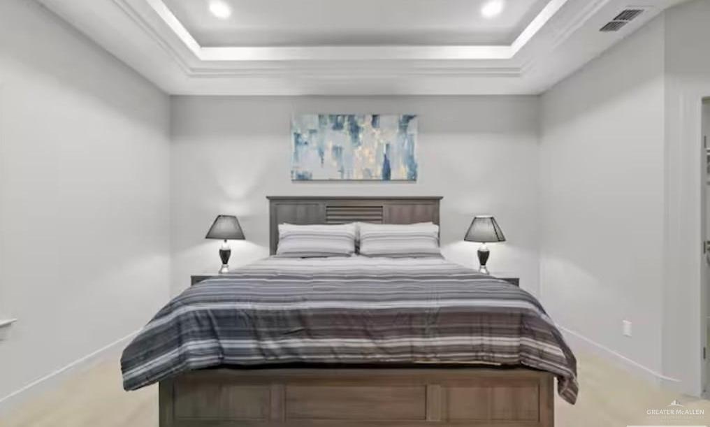 2310 Treasure Cove Harlingen, TX 78550 - Photo 7 of 23 a bedroom with a bed and a chandelier