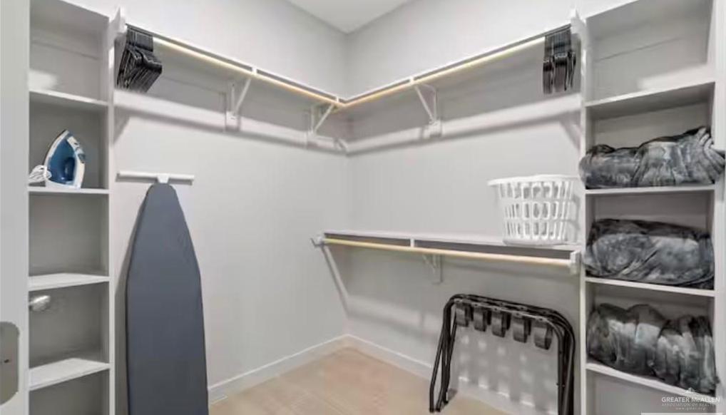 2310 Treasure Cove Harlingen, TX 78550 - Photo 8 of 23 a view of walk in closet with clothes and shoes