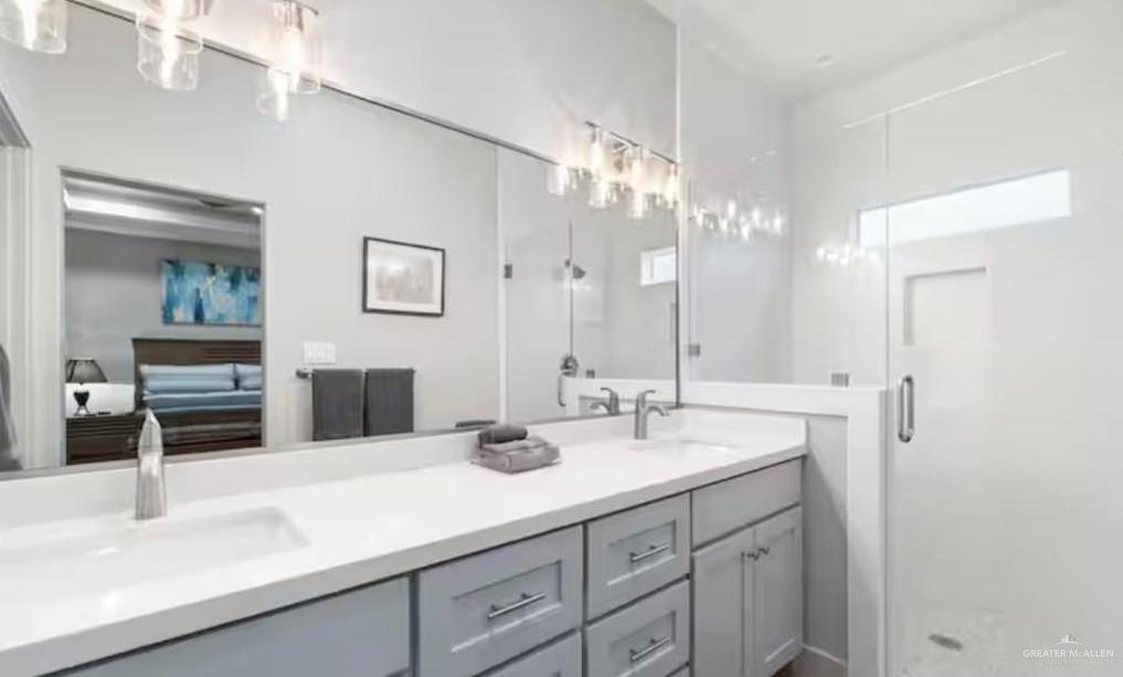 2310 Treasure Cove Harlingen, TX 78550 - Photo 10 of 23 a bathroom with double vanity sink and a mirror