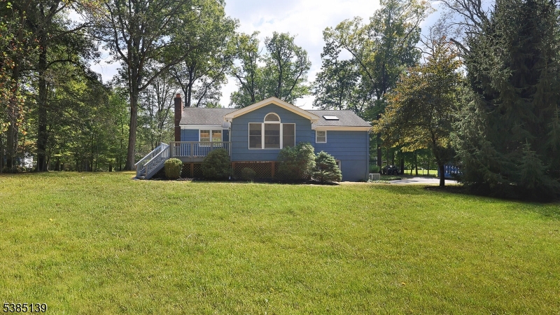 59 Ferguson Road Warren, NJ 07059 - Photo 23 of 26 a front view of a house with a garden and trees