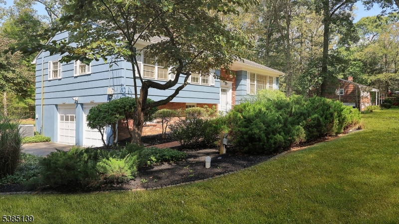 59 Ferguson Road Warren, NJ 07059 - Photo 3 of 26 a front view of a house with a yard and potted plants
