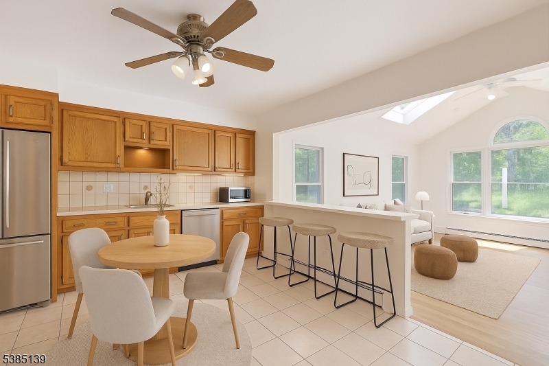 59 Ferguson Road Warren, NJ 07059 - Photo 5 of 26 a kitchen with a dining table chairs and refrigerator