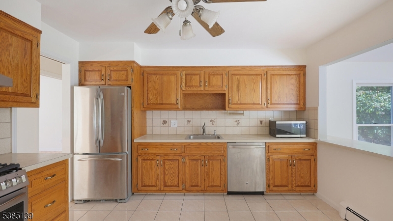 59 Ferguson Road Warren, NJ 07059 - Photo 7 of 26 a kitchen with a refrigerator sink and cabinets