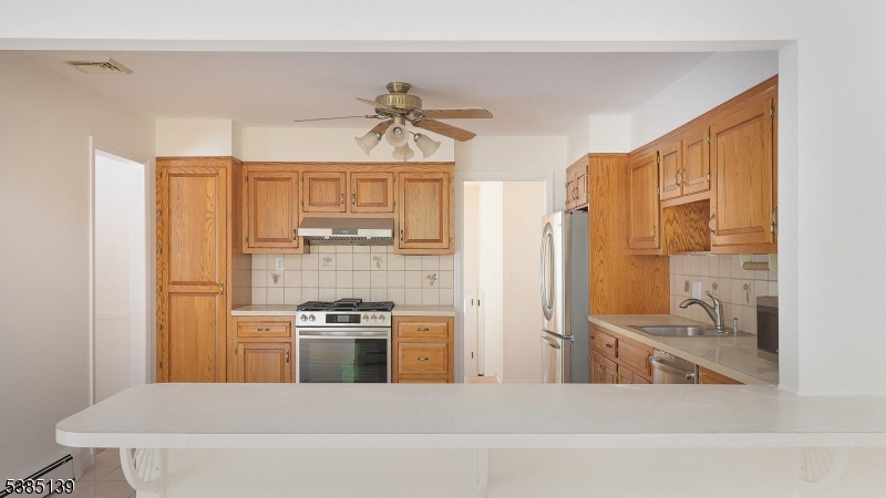 59 Ferguson Road Warren, NJ 07059 - Photo 8 of 26 a kitchen with stainless steel appliances a stove a refrigerator and a sink