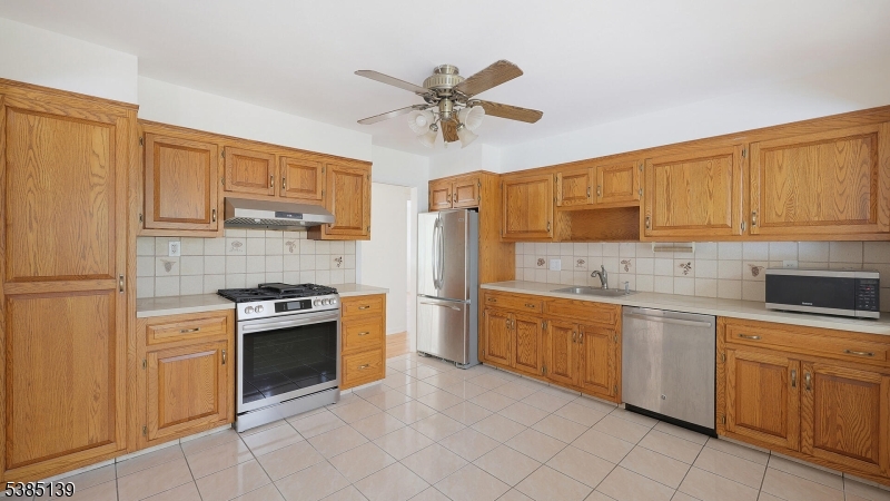 59 Ferguson Road Warren, NJ 07059 - Photo 9 of 26 a kitchen with stainless steel appliances granite countertop a stove sink and cabinets