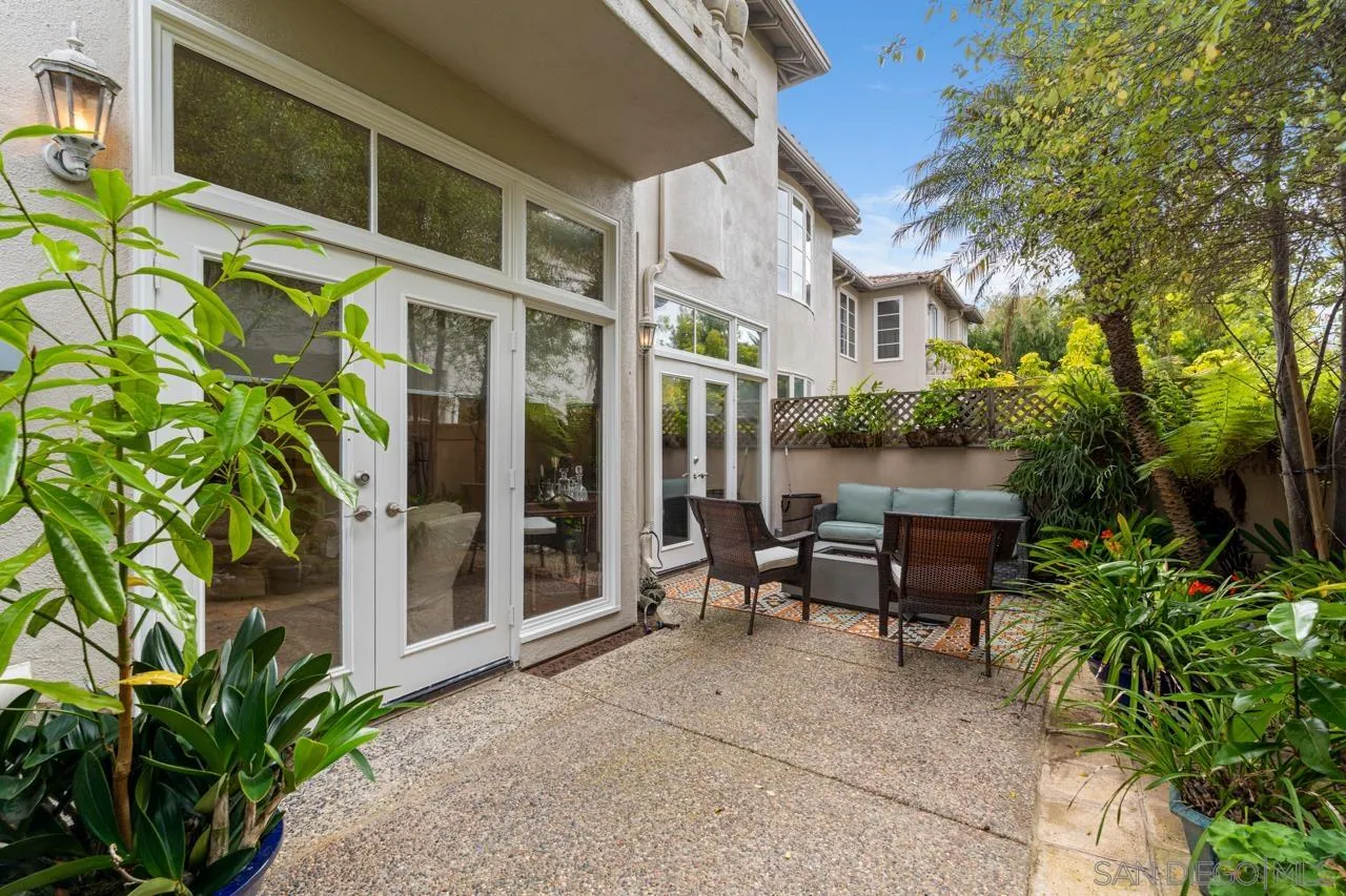 3128 Almahurst Row La Jolla, CA 92037 - Photo 12 of 21 a view of a patio with table and chairs potted plants with wooden fence