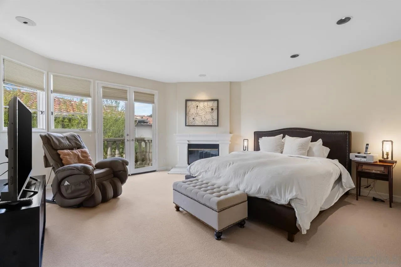 3128 Almahurst Row La Jolla, CA 92037 - Photo 13 of 21 a spacious bedroom with a bed and glass wall