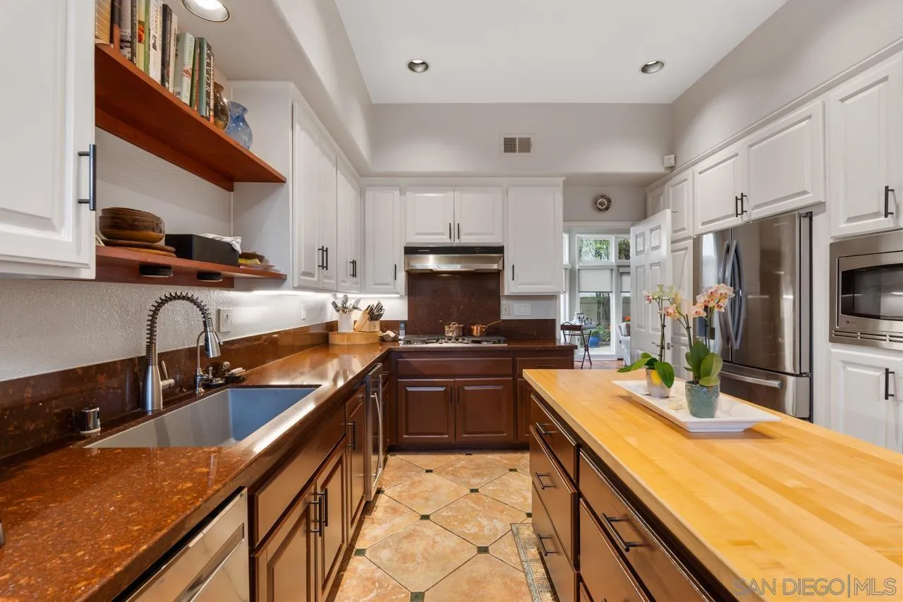 3128 Almahurst Row La Jolla, CA 92037 - Photo 9 of 21 a kitchen with granite countertop a sink stove and refrigerator