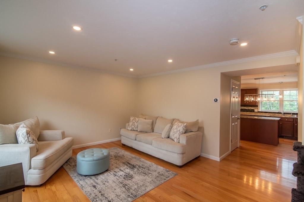1975 Middlesex Street, Unit 51 Lowell, MA 01851 - Photo 14 of 34 a living room with furniture and wooden floor