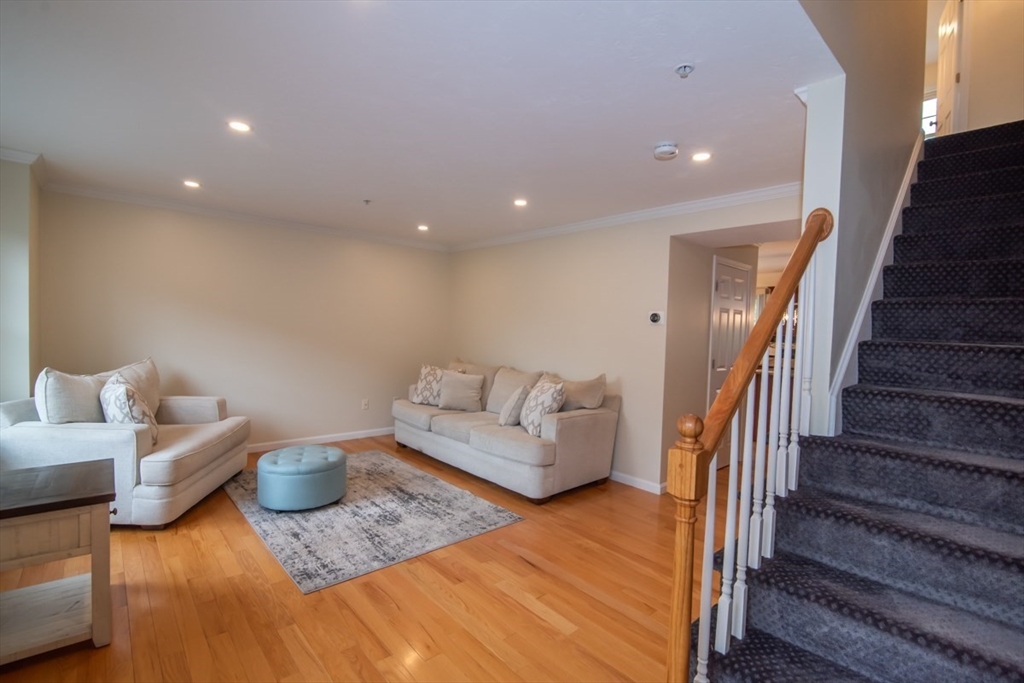 1975 Middlesex Street, Unit 51 Lowell, MA 01851 - Photo 15 of 34 a living room with furniture and stairs