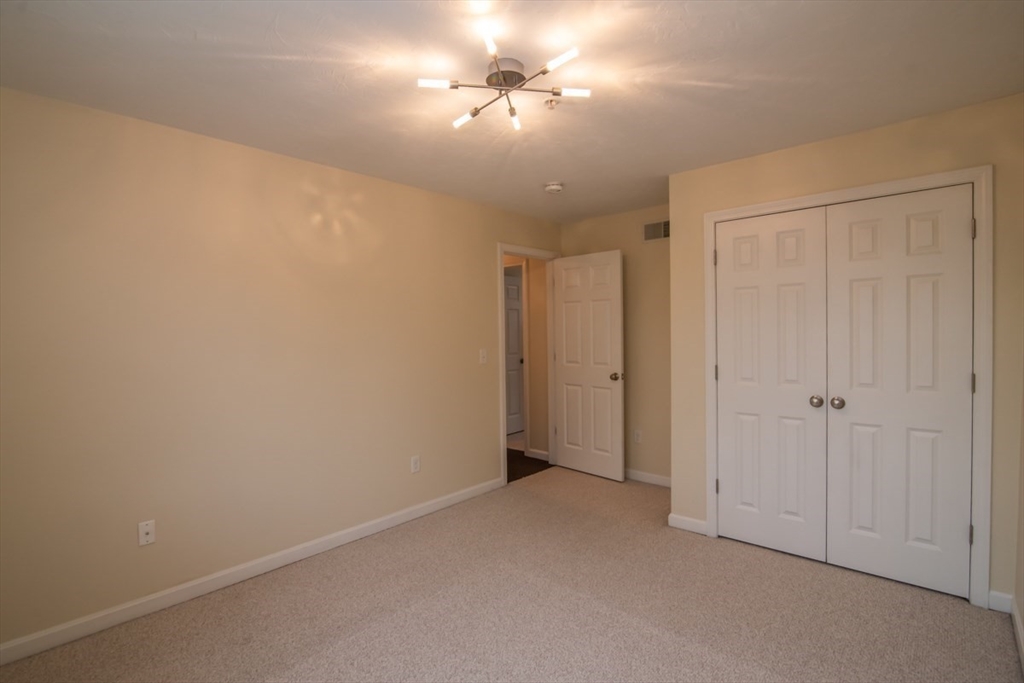 1975 Middlesex Street, Unit 51 Lowell, MA 01851 - Photo 23 of 34 a view of a room with a ceiling fan and a window