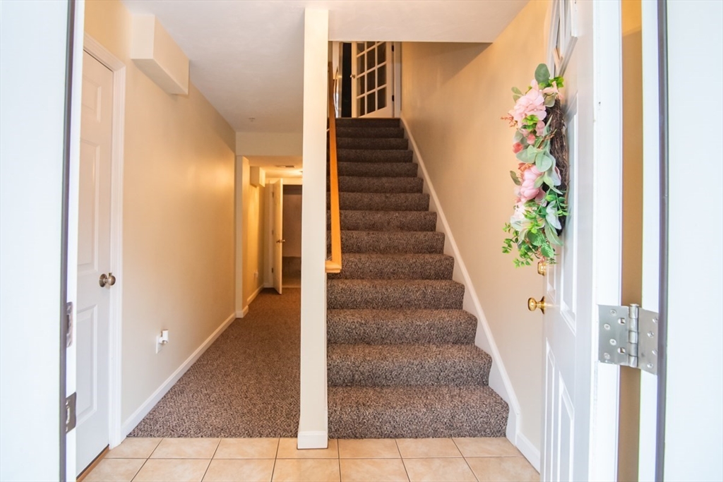 1975 Middlesex Street, Unit 51 Lowell, MA 01851 - Photo 3 of 34 a view of a hallway with wooden floor and stairs