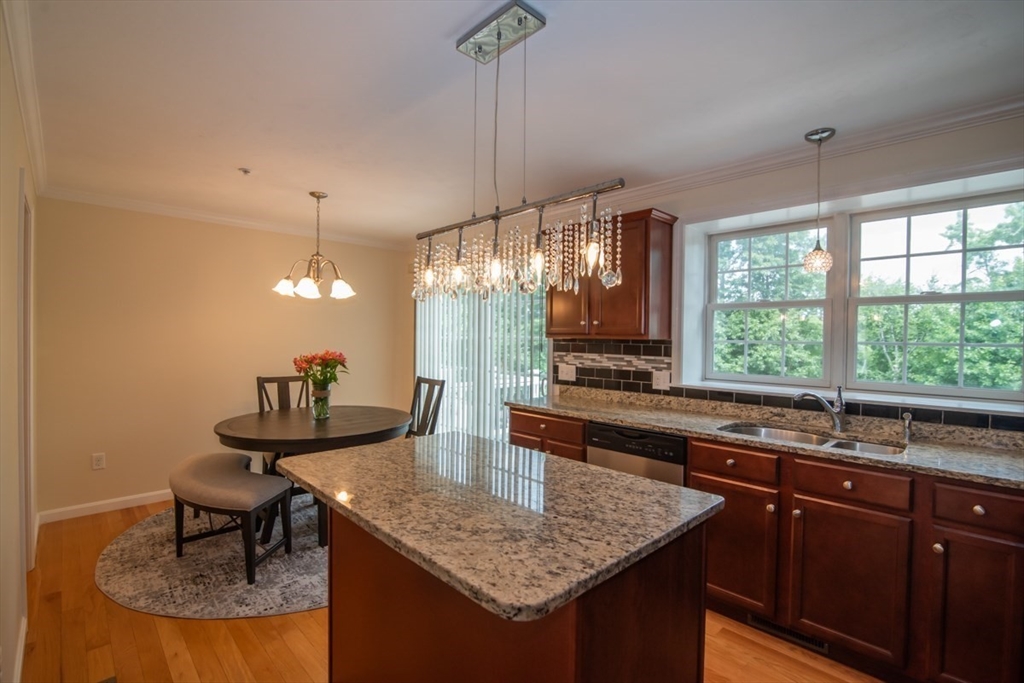 1975 Middlesex Street, Unit 51 Lowell, MA 01851 - Photo 7 of 34 a kitchen with center island table and chairs in it