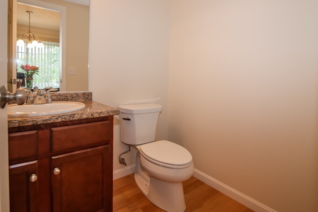 1975 Middlesex Street, Unit 51 Lowell, MA 01851 - Photo 10 of 34 a bathroom with a granite countertop toilet and a sink
