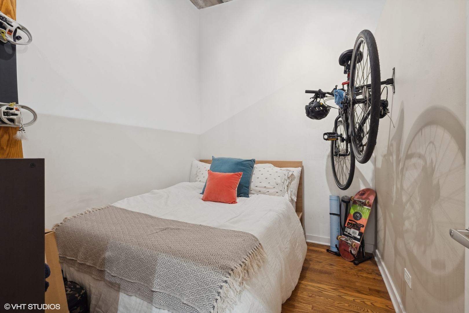 1069 West 14th Place, Unit 305 Chicago, IL 60608 - Photo 11 of 15 a bedroom with a bed and a chandelier