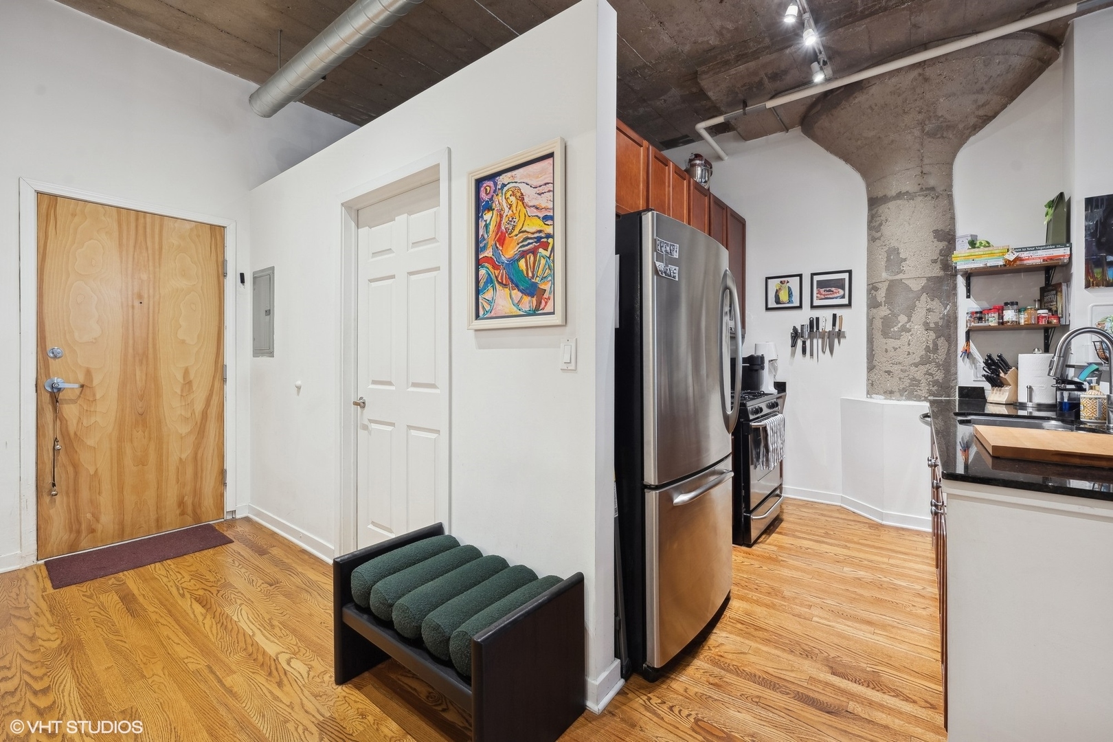 1069 West 14th Place, Unit 305 Chicago, IL 60608 - Photo 2 of 15 a view of hallway with furniture and a refrigerator
