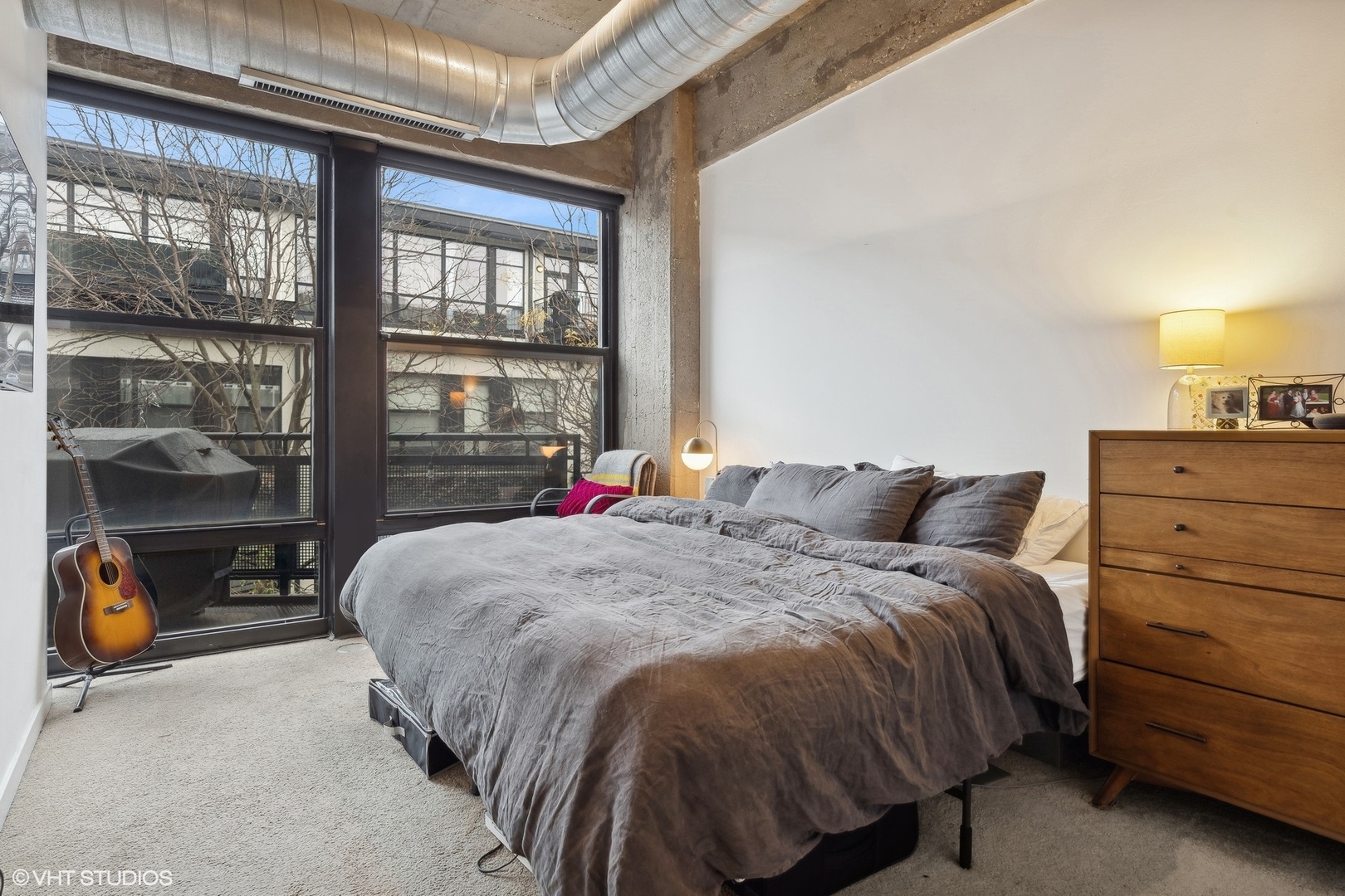 1069 West 14th Place, Unit 305 Chicago, IL 60608 - Photo 10 of 15 a bed sitting in a bedroom next to a window