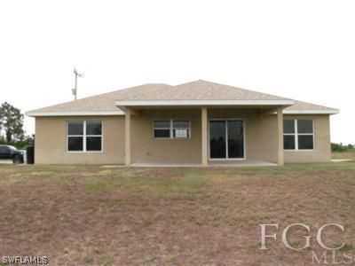 2805 23rd Street Southwest Lehigh Acres, FL 33976 - Photo 2 of 10 a front view of a house with a garden
