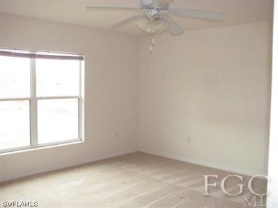 2805 23rd Street Southwest Lehigh Acres, FL 33976 - Photo 9 of 10 an empty room with a window