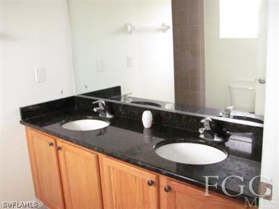 2805 23rd Street Southwest Lehigh Acres, FL 33976 - Photo 10 of 10 a bathroom with a sink and a mirror
