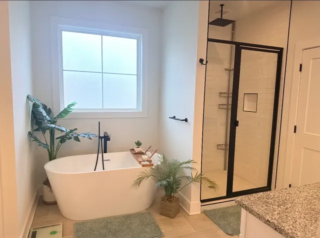 a white bath tub sitting next to a shower