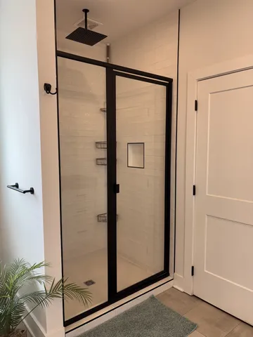 a bathroom with a glass shower door