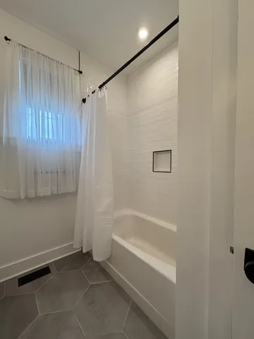 a bathroom with a bathtub and a shower