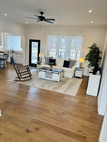 a living room with furniture and kitchen view