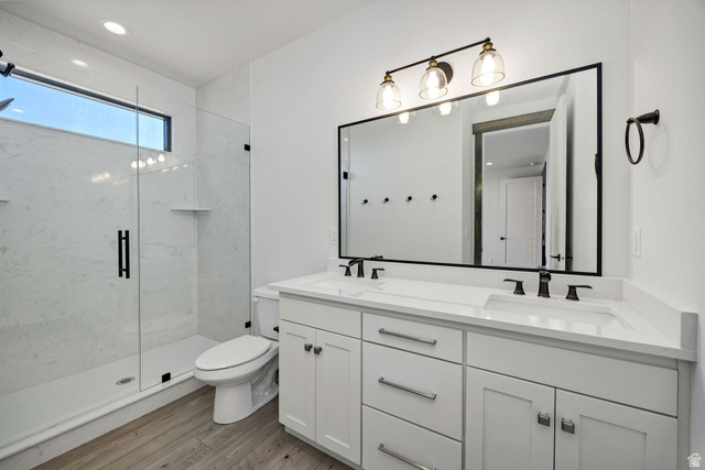 300 Knoll Loop, Unit 227 Fish Haven, ID 83287 - Photo 14 of 56 Full bath with double vanity, a marble finish shower, light wood finished floors, and recessed lighting