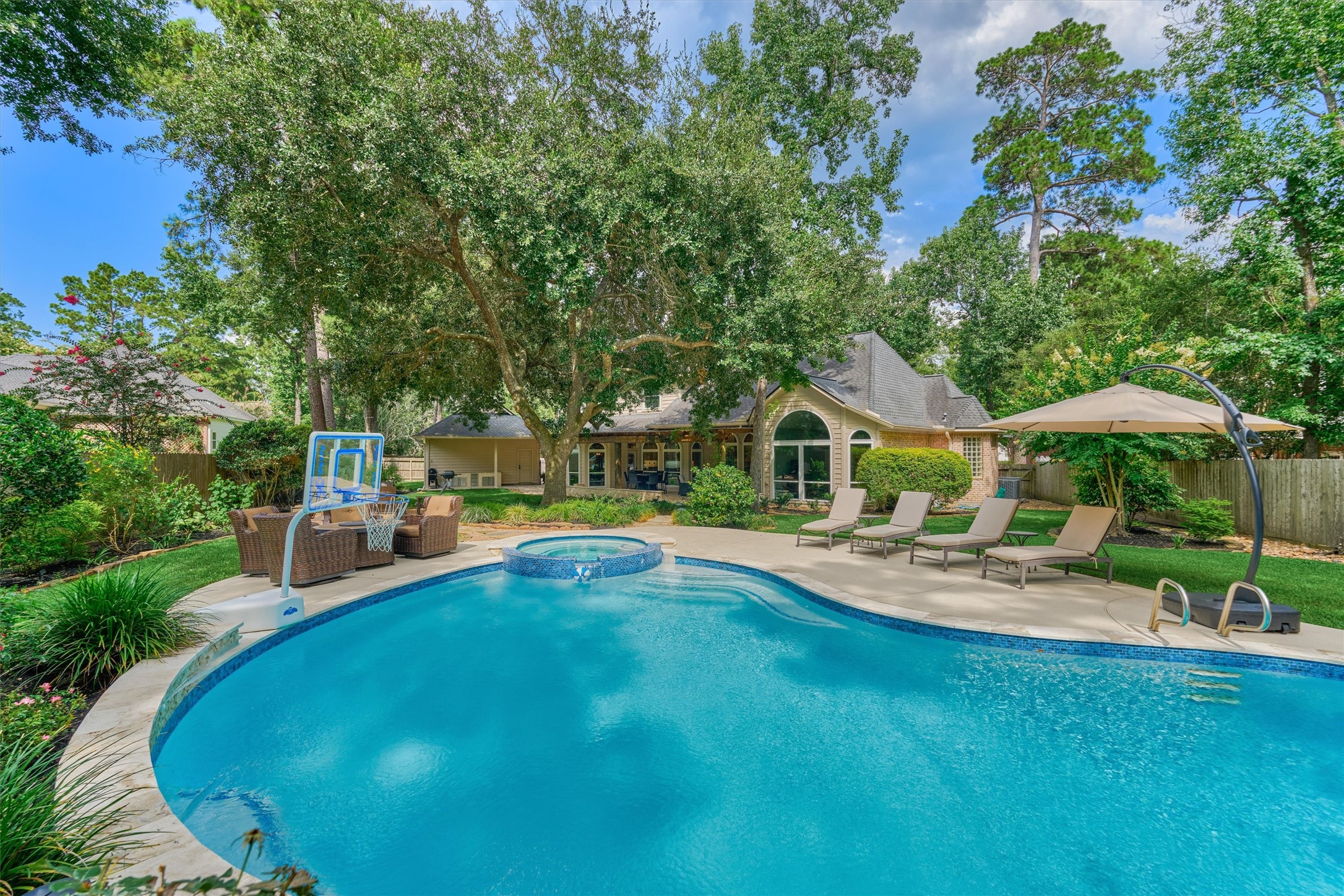 18 Treevine Court The Woodlands, TX 77381 - Photo 37 of 50 Take a refreshing dip in the sparkling backyard pool and enjoy Texas summers in your own private retreat.