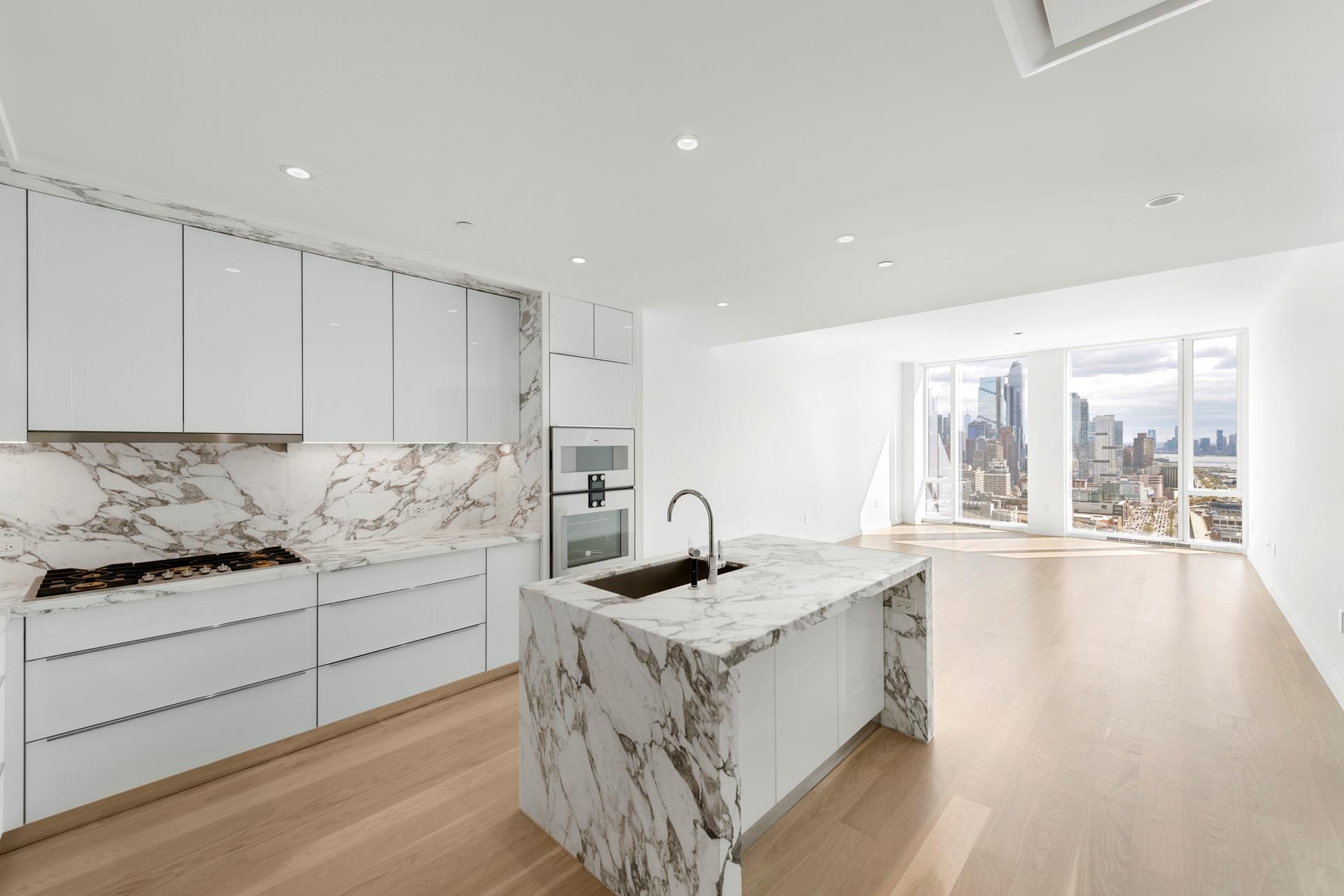 a kitchen with granite countertop a sink and a stove top oven