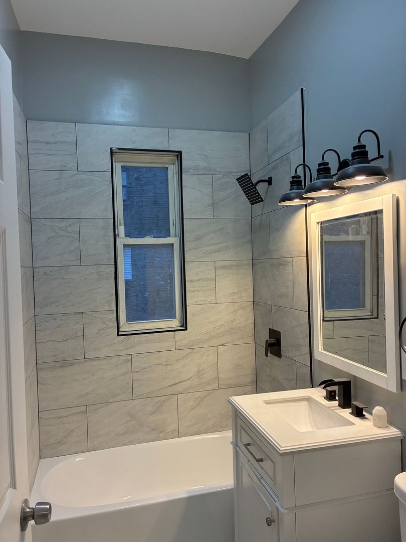 5543 South Shields Avenue Chicago, IL 60621 - Photo 11 of 12 a bathroom with a sink and a bathtub