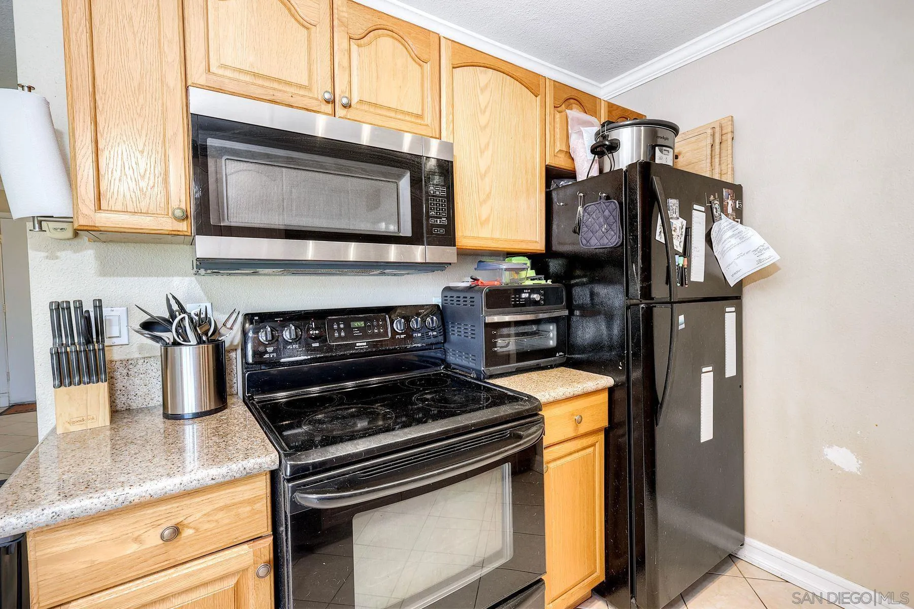 12923 Mapleview Street, Unit 6 Lakeside, CA 92040 - Photo 7 of 25 a kitchen with stainless steel appliances granite countertop a stove and a microwave