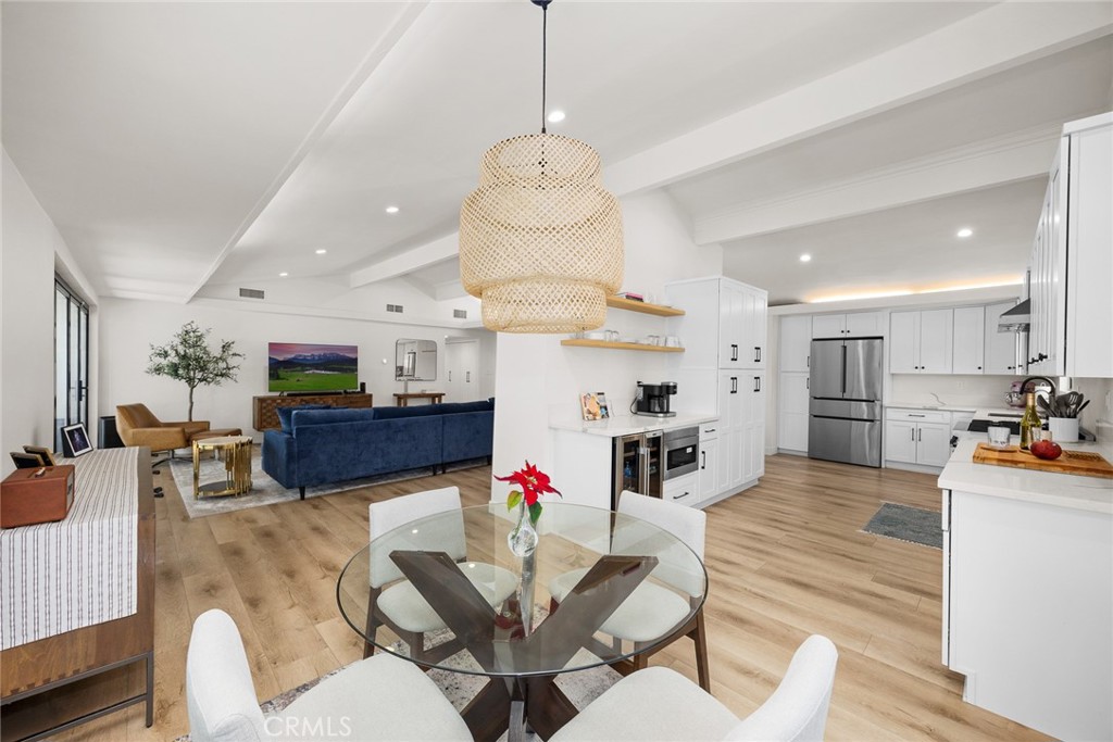 18234 Tribune Street Porter Ranch, CA 91326 - Photo 12 of 26 a living room with furniture kitchen view and a chandelier