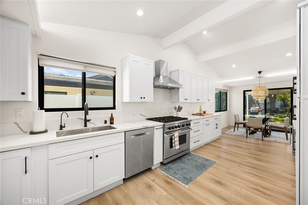 18234 Tribune Street Porter Ranch, CA 91326 - Photo 13 of 26 a kitchen with a sink stove and wooden cabinets