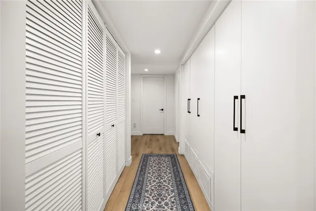 a spacious bedroom with a bed and a large window