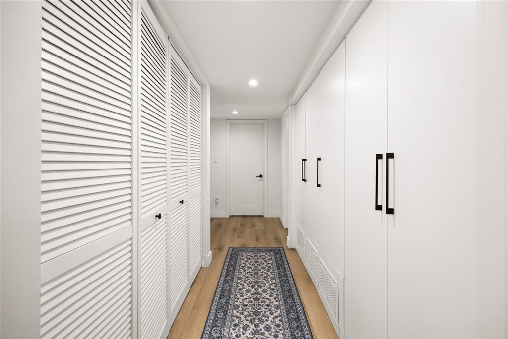18234 Tribune Street Porter Ranch, CA 91326 - Photo 16 of 26 a view of a hallway with wooden floor and staircase