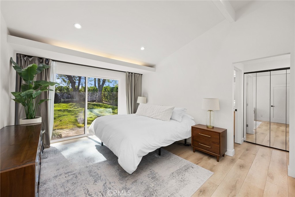 18234 Tribune Street Porter Ranch, CA 91326 - Photo 17 of 26 a spacious bedroom with a bed and a large window